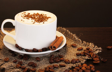 Latte on wooden table on brown background