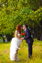 bride and groom at wedding are in green forest of oak and kiss