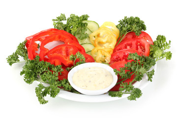 Chopped vegetables and sauce on plate isolated on white