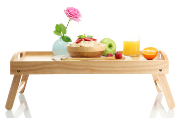 light breakfast on wooden tray isolated on white