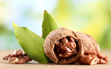 walnuts with green leaves, on green background