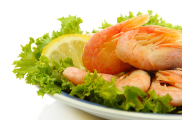 Boiled shrimps with lemon and lettuce leaves