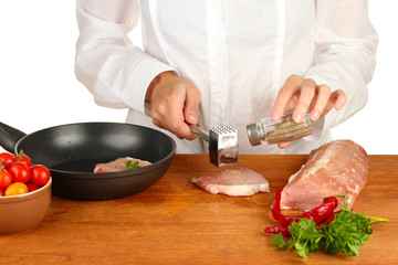 Chef cooking meat on wooden table