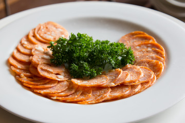 ham on white dish and green leaf