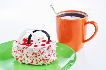 Cup of coffee and sweet cake on a green plate for breakfast