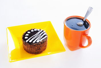 Round chocolate cake with cup of coffee