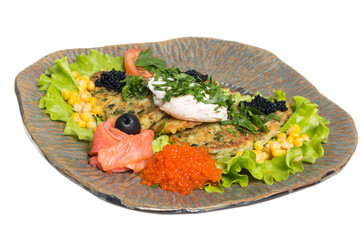 Roasted cutlets of potato with salmon on a plate