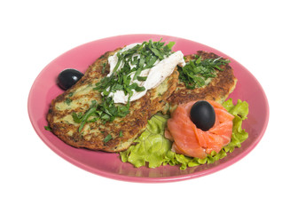 Roasted cutlets of potato with salmon on a plate