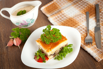 Casserole with mushrooms, meat and spices.