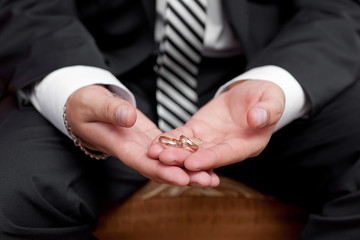 Gold wedding rings on a hand of the groom