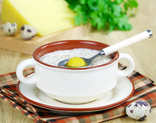 Oatmeal with herbs, cheese and quail egg