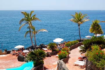 View on the beach, palms and swimming pool of luxury hotel, Tene