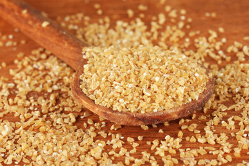 arnautka in wooden spoon on wooden background close-up
