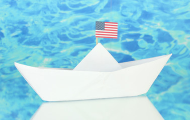 Ship with the American flag, on blue background. Columbus Day.