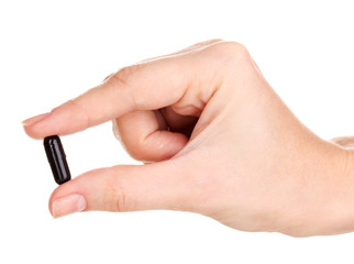 activated carbon in hand isolated on white