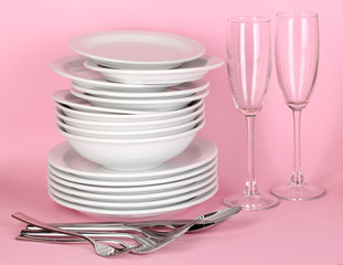 Clean white dishes on pink background