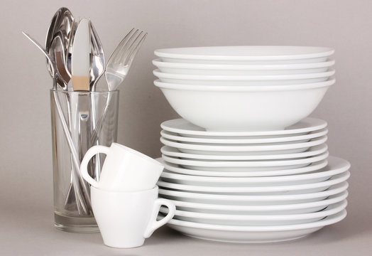 Clean white dishes on grey background