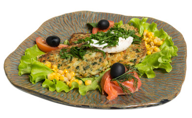 Roasted cutlets of potato with salmon on a plate