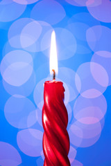 red candle light on blue background