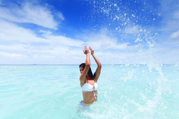 Woman splashing in sea