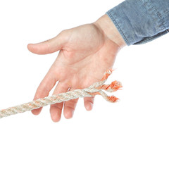 Man's hand catching broken end of the rope.