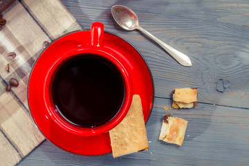 Red cup of coffee with cookie