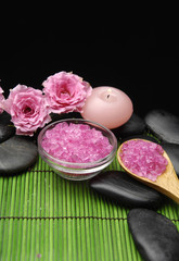 Fototapeta na wymiar rose and stones with herbal salt in bowl with candle
