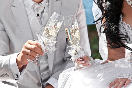 Wedding champagne in hands of bride and groom