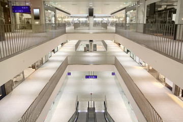 Escalator and three floors in modern large shopping center