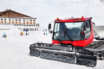 Red machine for skiing slope preparations in Austrian Alps