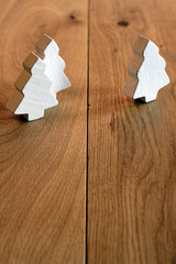 White Christmas trees on a wooden background
