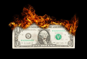 Burning dollar bill symbolizing careless money management