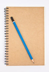 Blue pencil on brown notebook's cover.