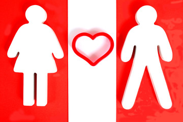 Male and female figure with heart between them