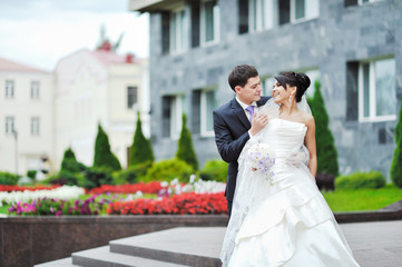 Happy bride and groom in a park. Wedding couple