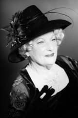 Senior woman glamour vintage style. Black and white studio shot.