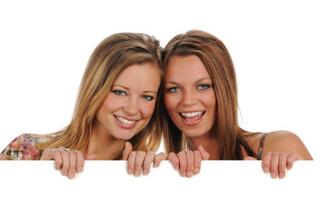 Two beautiful Women holding a blank sign