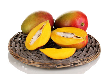 Ripe appetizing mango on wicker cradle isolated on white