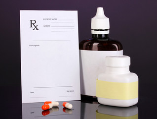 Pharmacist prescription with drops and pills isolated on purple