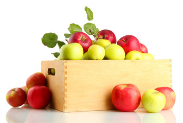 juicy apples with green leaves in wooden crate, isolated