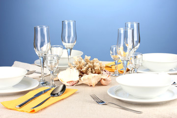 Table setting in white and yellow tones on color  background