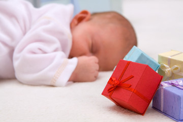 Baby Sleeping By Gift Boxes