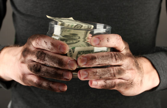 homeless holds bank with money, close-up