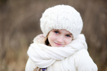Close-up outdoor portrait of smiling little girl
