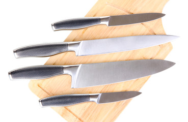 Set of knives on cutting board isolated on white