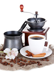 White cup of Turkish coffee with coffee mill and coffee pot