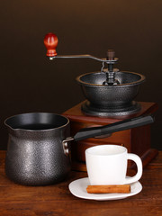 Obraz na płótnie Canvas Ekspres do kawy z młyna i filiżanki kawy białego na drewnianych tabeli