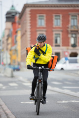 Cyclist With Courier Bag Using Walkie-Talkie