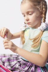 portrait of a little caucasian fashionable girl using decorative