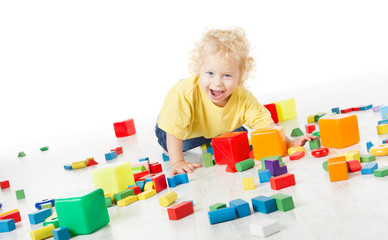 Child happy playing blocks toys over white